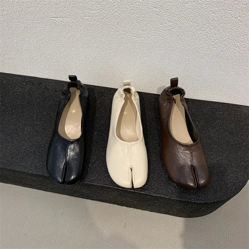 Women's round toe pumps with a split toe horseshoe design and a low chunky heel.