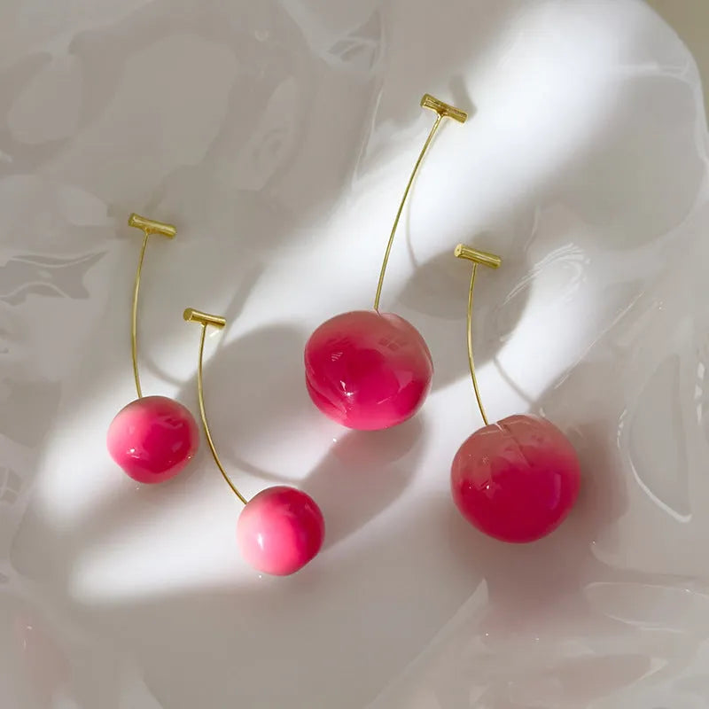 A pair of colourful acrylic peach-shaped earrings with copper posts, shown in small and large size options.