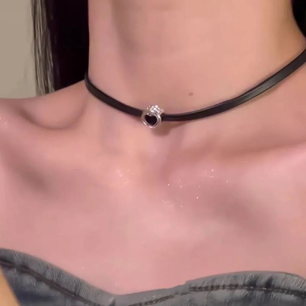 Women's adjustable leather heart pendant necklace with alloy chain and artificial crystal details on a model.