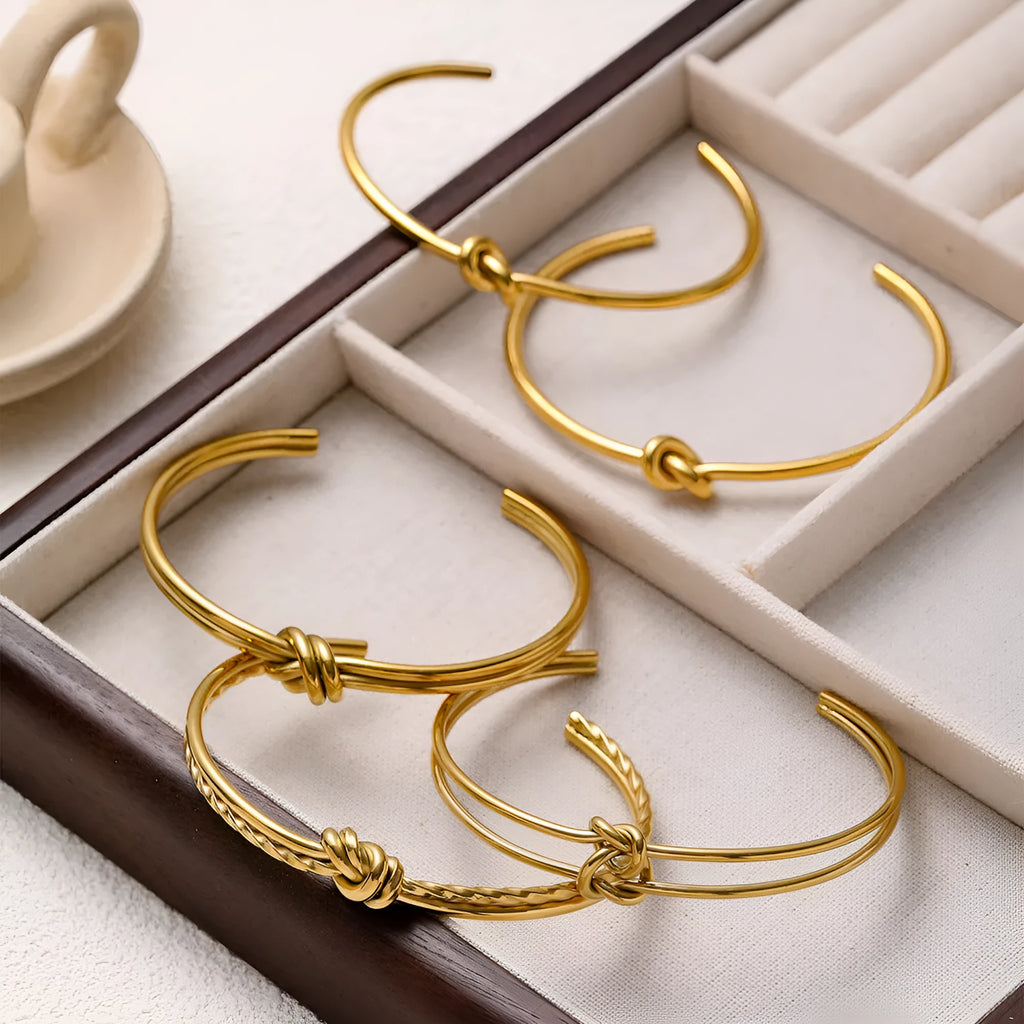 Women's adjustable knotted C-shaped bracelet in stainless steel with gold plating