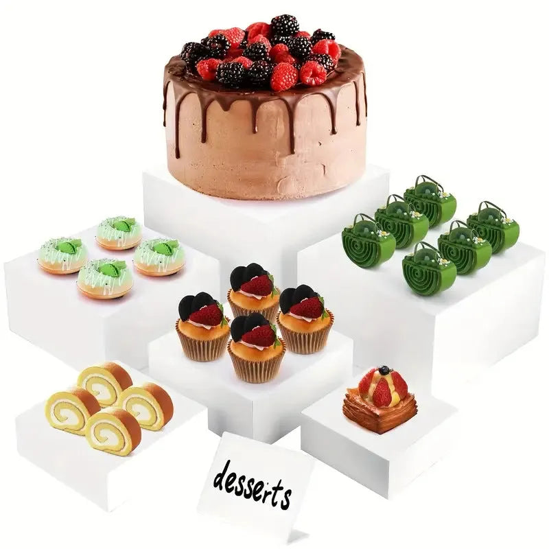 White plastic cube-shaped dessert display stand with multiple tiers for cupcakes and pastries.