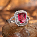Copper square women's ring with a central red rhinestone on a hand model.