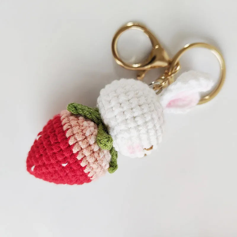 Hand-woven white doll wire pendant with a rabbit strawberry charm and an attached key