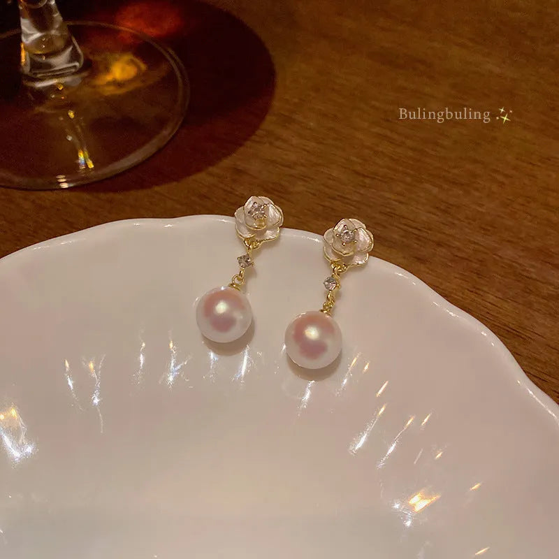 Camellia flower stud earrings in alloy metal with floral design