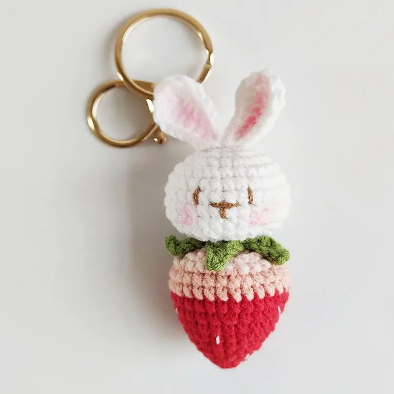 Hand-woven white doll wire pendant with a rabbit strawberry charm and an attached key