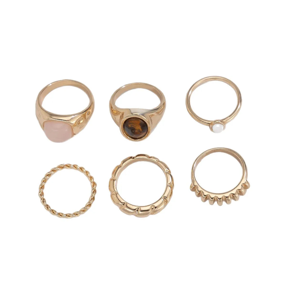 Six geometric irregular shaped alloy rings in light gold electroplated finish displayed together