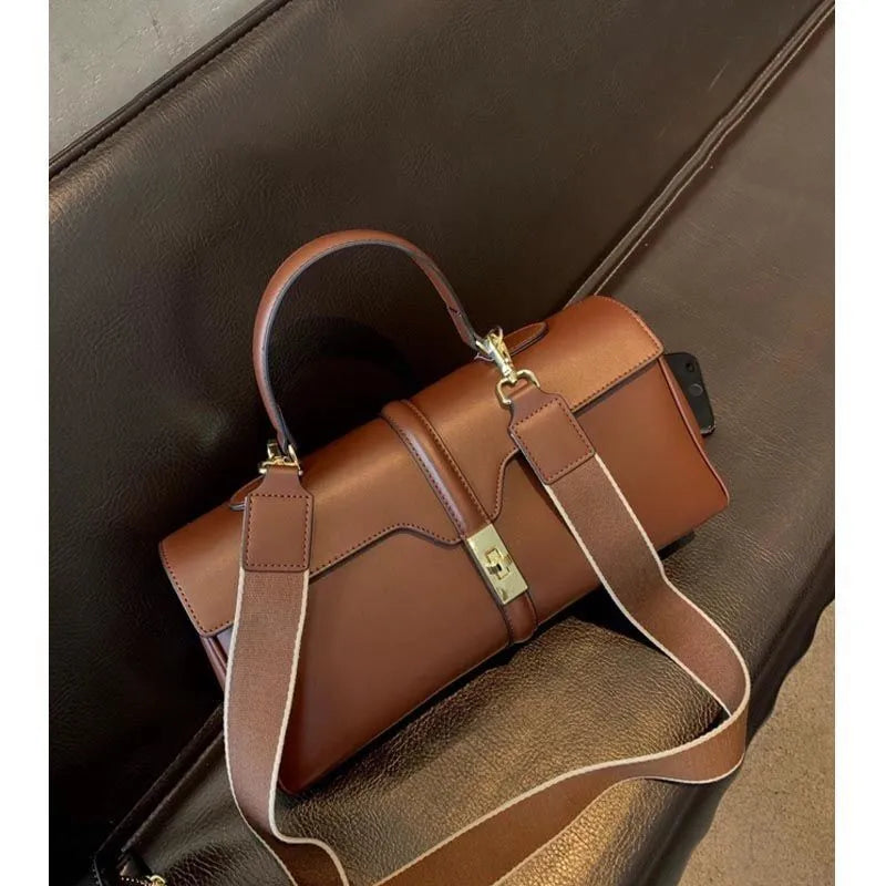 Women's cylindrical cowhide messenger bag in retro style with organised interior compartments