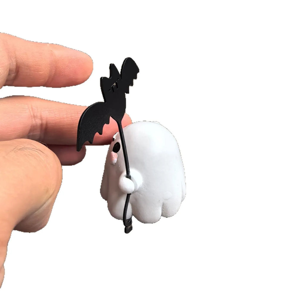 Miniature white ghost dog walking statue holding a small black bat, resin Halloween ornament