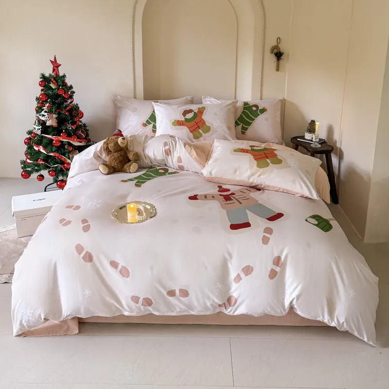 Cartoon Christmas duvet cover and pillowcase set in red and green on a bed.
