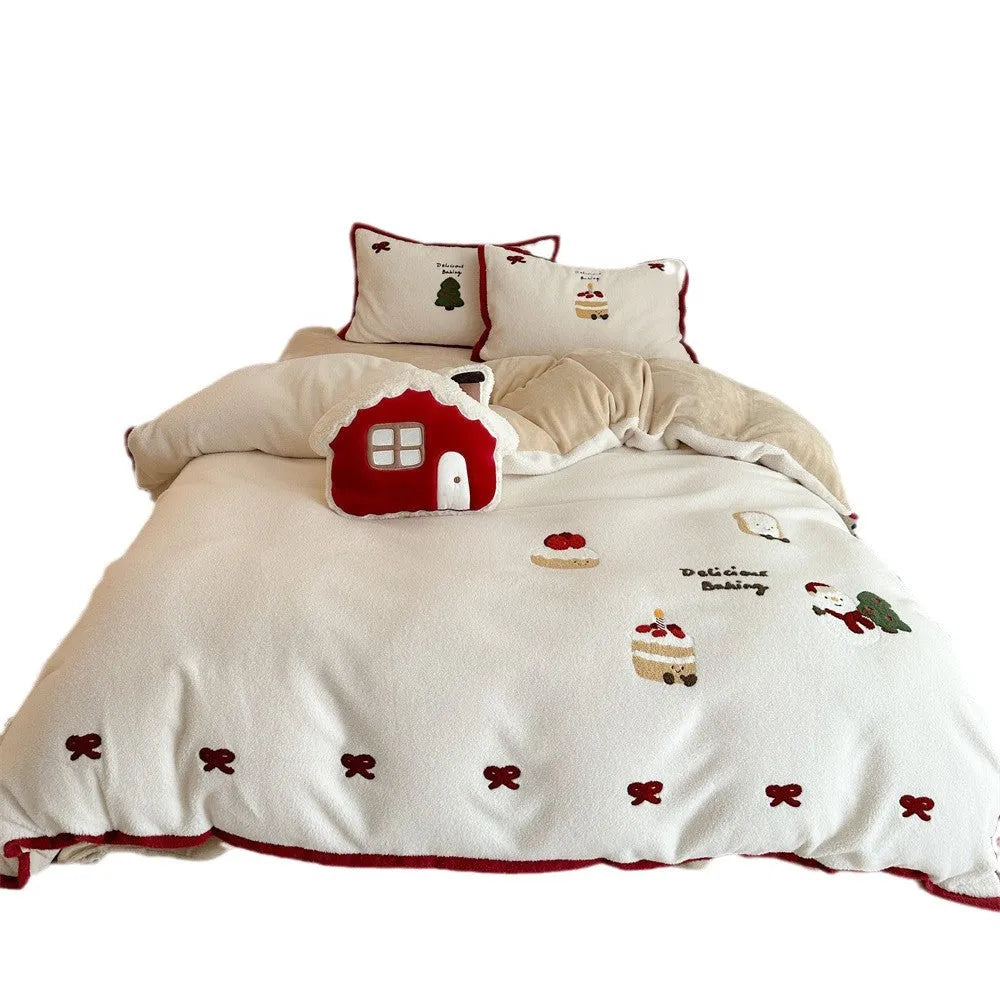 Cartoon pattern winter bedding four-piece set including bed sheet, duvet cover, and pillowcases on a bed.