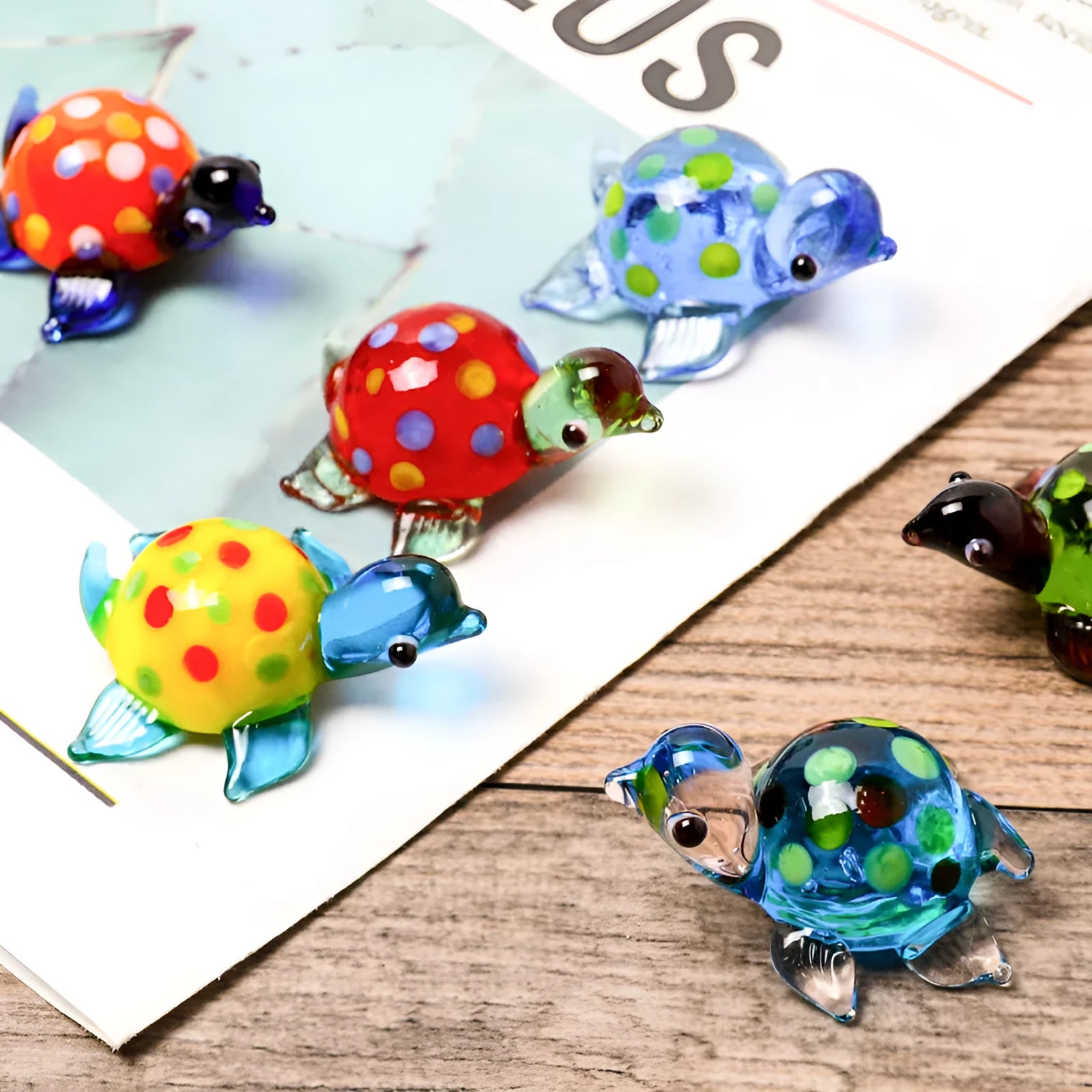 Modern geometric glass turtle ornament on a desk in blue head and blue shell colour variation.