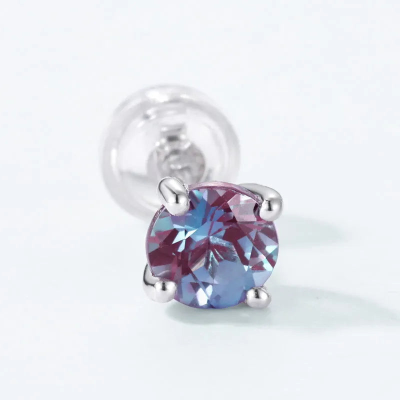 A pair of round geometric stud earrings with a cultivated alexandrite stone set in 925 silver.