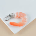 PVC injection moulded shrimp-shaped keychain and bag pendant with door buckle on white background.