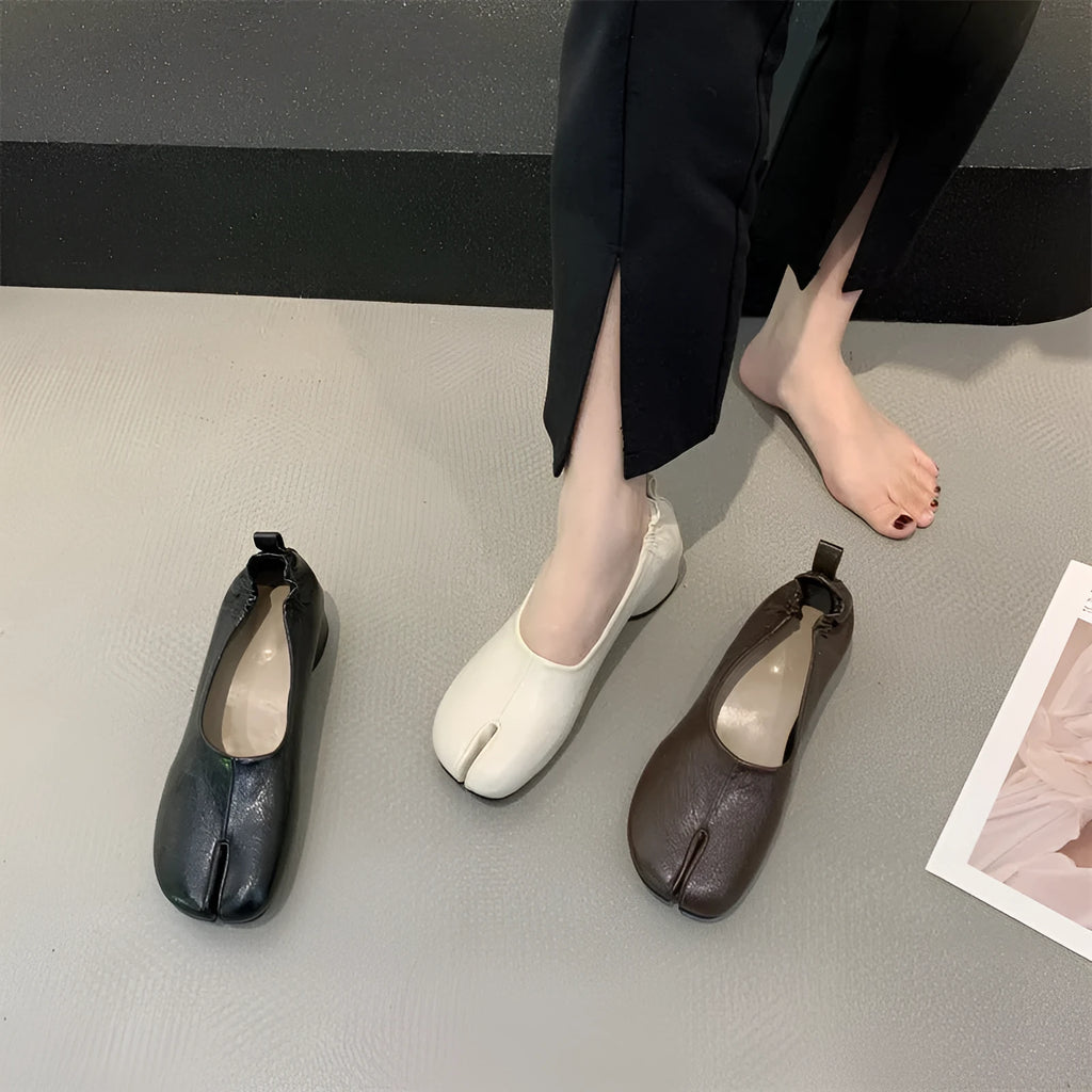 Women's round toe pumps with a split toe horseshoe design and a low chunky heel.
