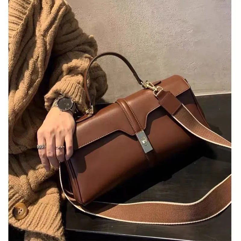 Women's cylindrical cowhide messenger bag in retro style with organised interior compartments