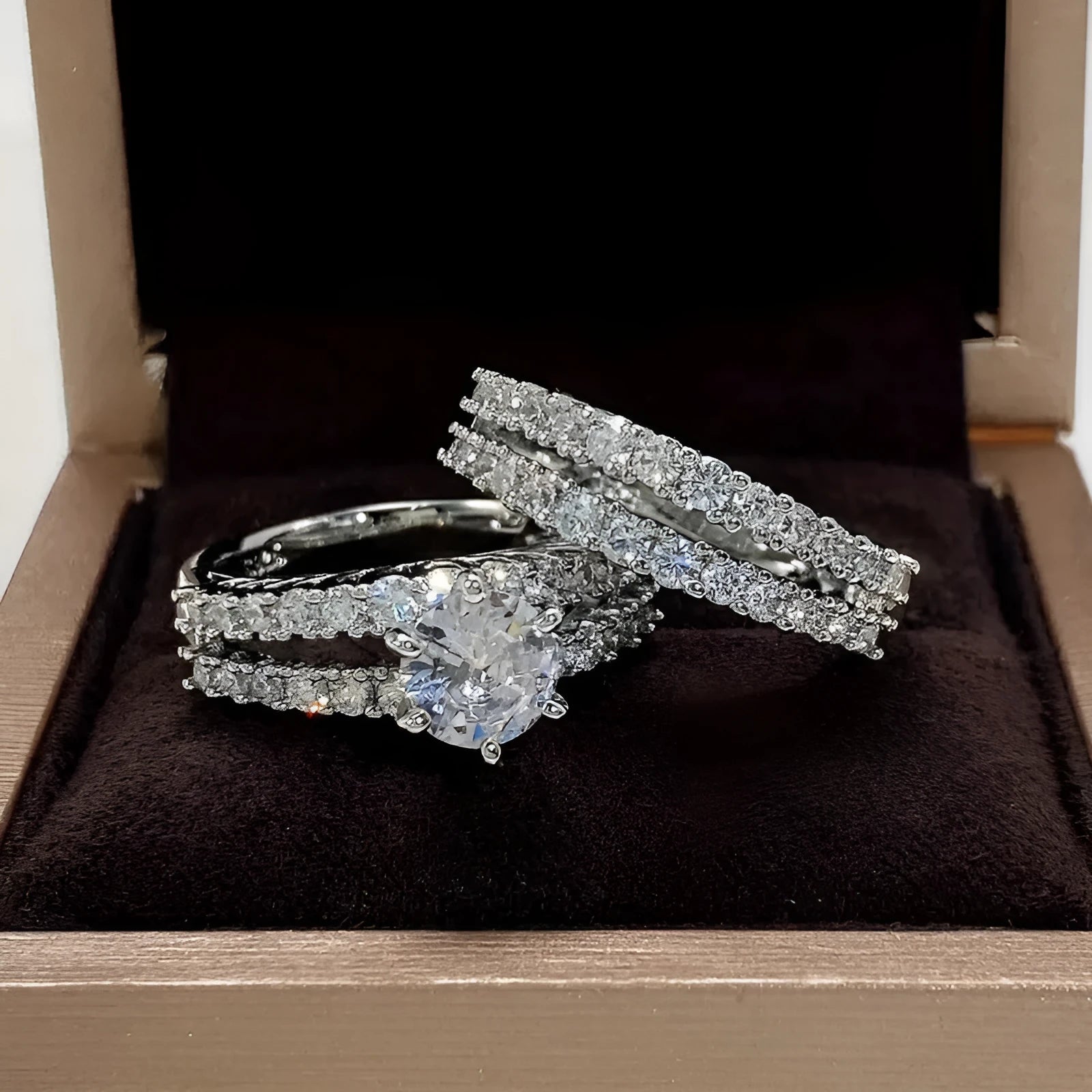 2 in 1 fully jewelled female fashion ring set in silver, gold, and rose gold on a geometric background.