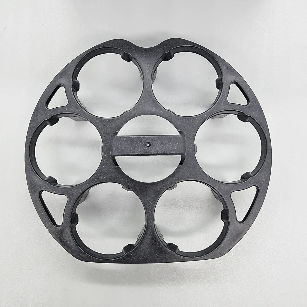 Black plastic egg holder cooking basket rack with retainer on a kitchen counter.