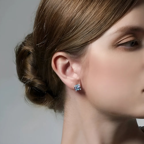 A pair of round geometric stud earrings with a cultivated alexandrite stone set in 925 silver.