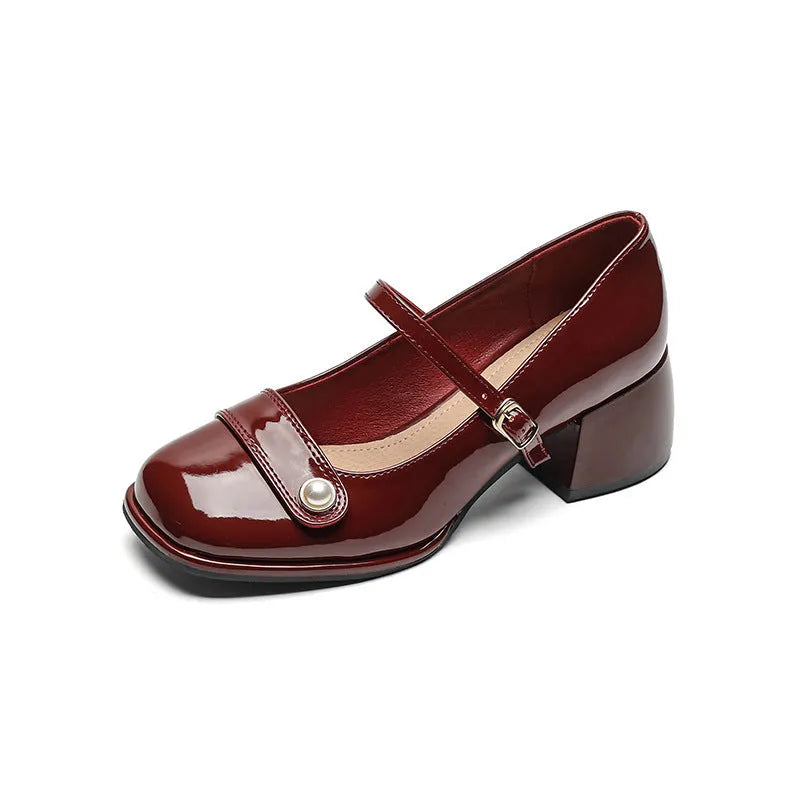 Women's apricot patent leather ankle boots with a chunky heel and ankle buckle.