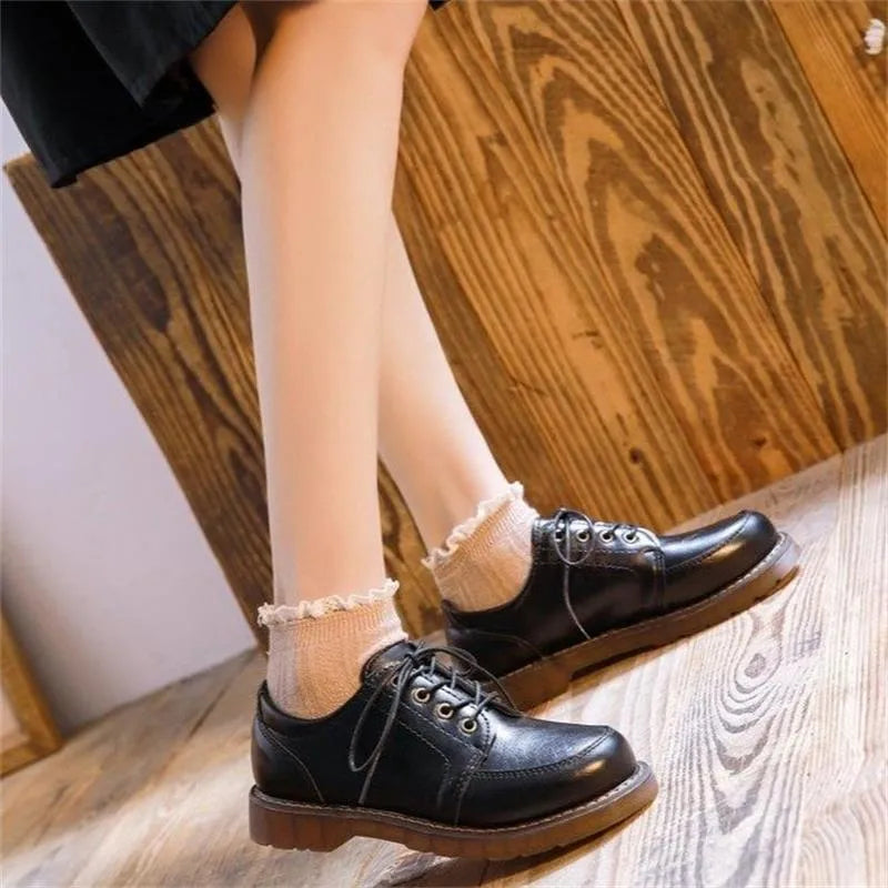 Women's preppy style black and brown retro Mary Jane lace-up pumps with low square heel.