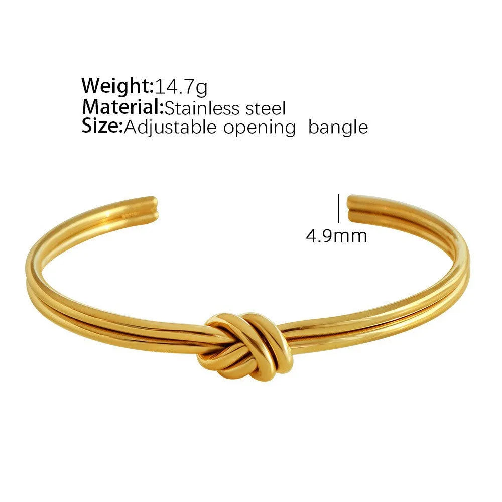 Women's adjustable knotted C-shaped bracelet in stainless steel with gold plating