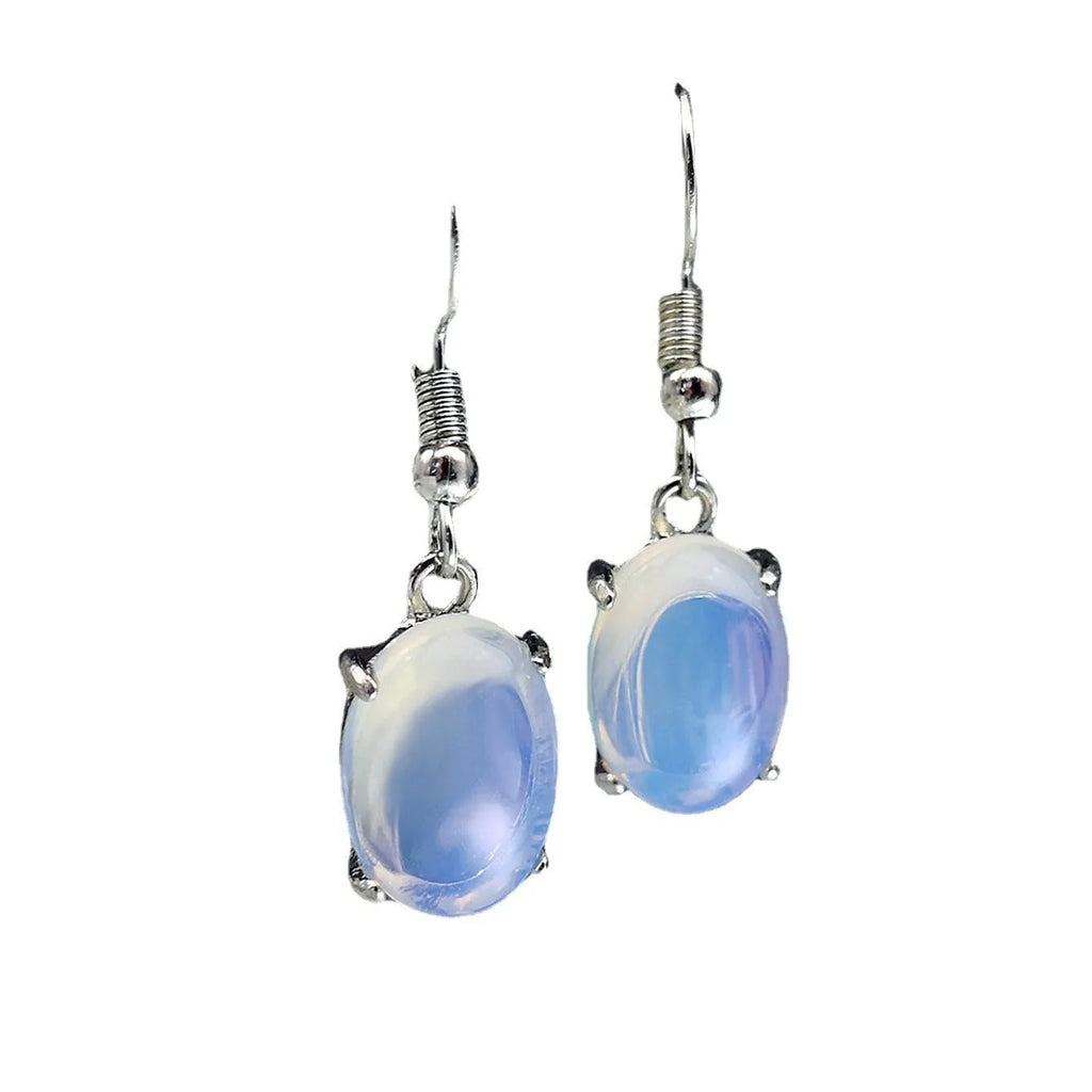 Pair of retro-style drop earrings with a moonlight opal colour and cross detail on an alloy base.
