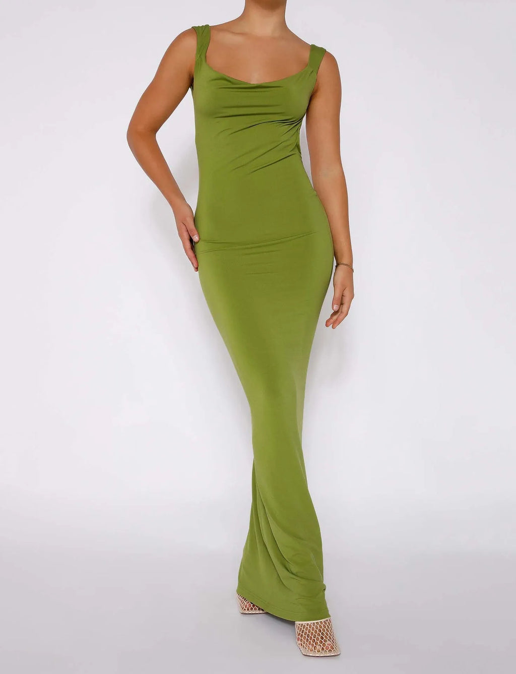 Women's backless sling dress with spaghetti straps in milk silk fabric, showing high waist and hip skirt design