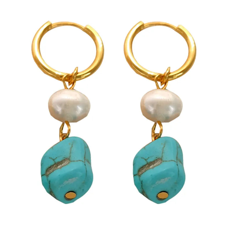 A pair of geometric copper earring clips with turquoise stones and cultured pearls, one short and one long.