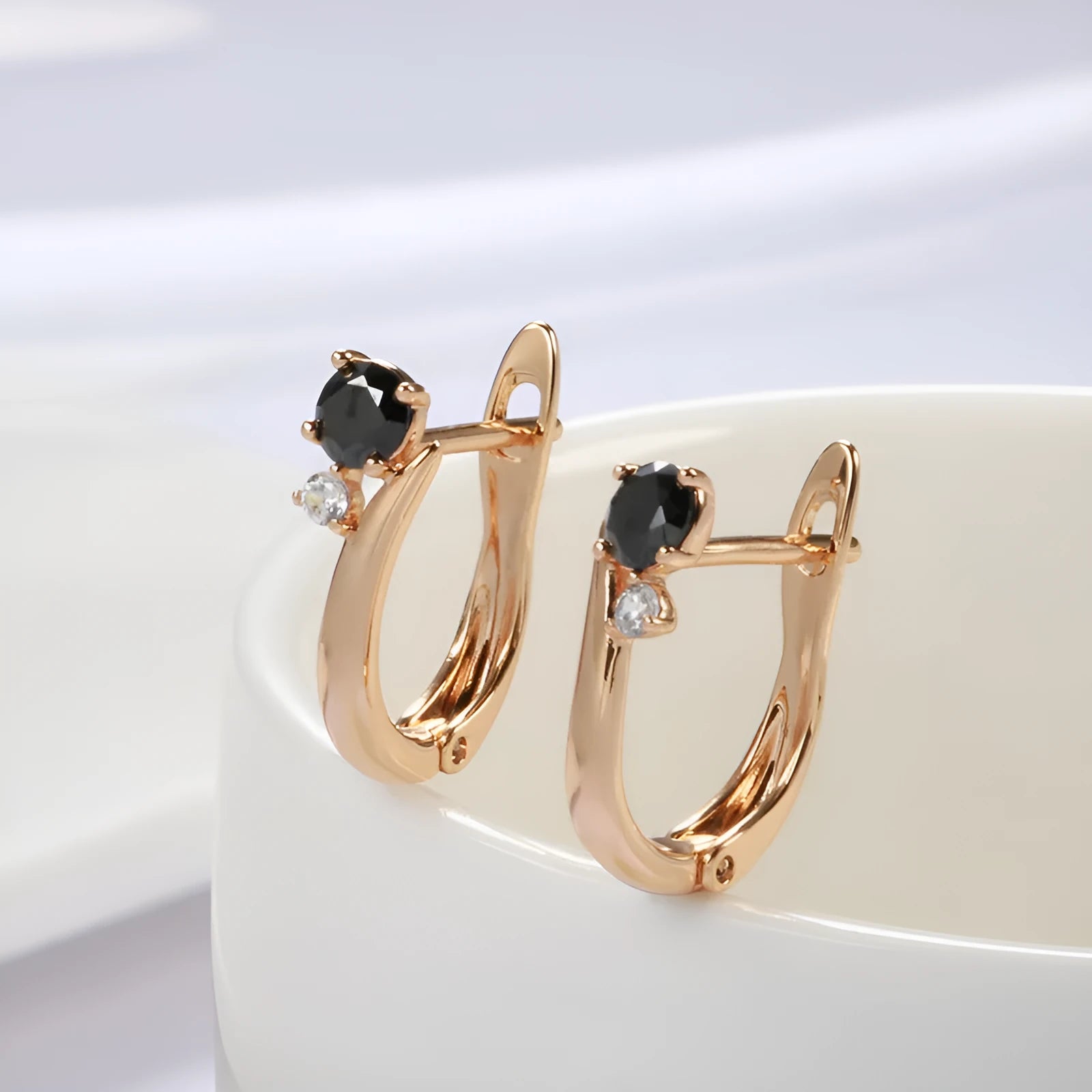 Women's black agate geometric drop earrings with gold plating and ear clip fastening