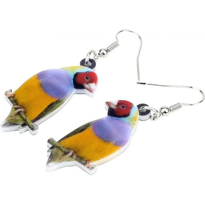 A pair of blue, white, and black acrylic drop earrings featuring a detailed Blue Tit bird and geometric snake patterns on a white background.