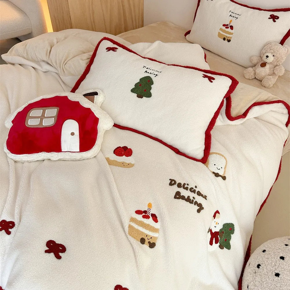 Cartoon pattern winter bedding four-piece set including bed sheet, duvet cover, and pillowcases on a bed.
