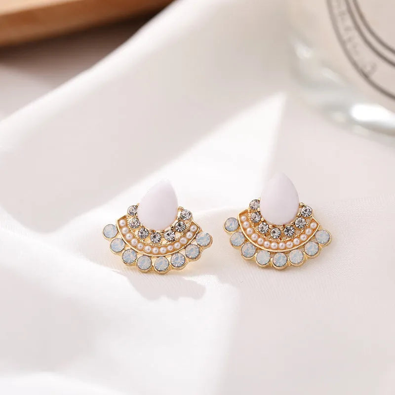 Women's retro fan-shaped silver earrings with opal and rhinestone details on an alloy setting.