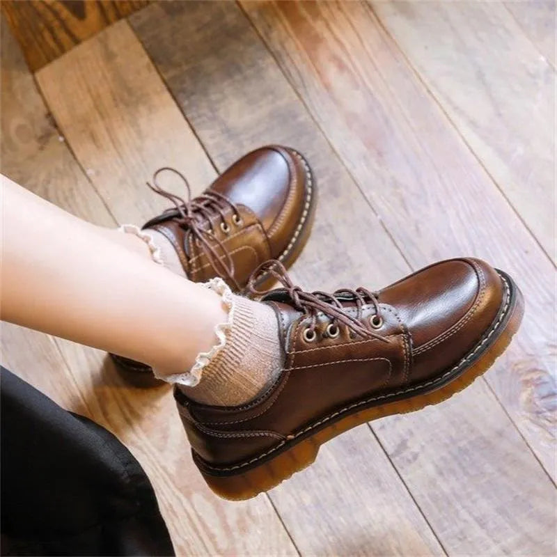 Women's preppy style black and brown retro Mary Jane lace-up pumps with low square heel.