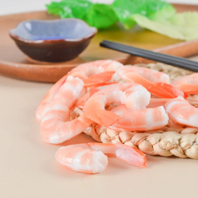 PVC injection moulded shrimp-shaped keychain and bag pendant with door buckle on white background.