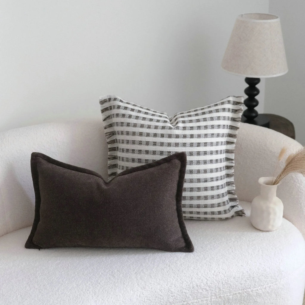 Coffee brown striped Chinese classical style decorative cushion on a sofa.