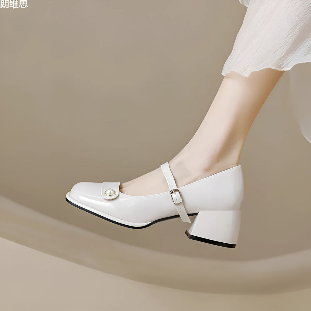 Women's apricot patent leather ankle boots with a chunky heel and ankle buckle.