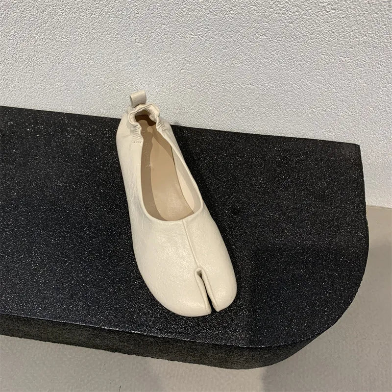 Women's round toe pumps with a split toe horseshoe design and a low chunky heel.