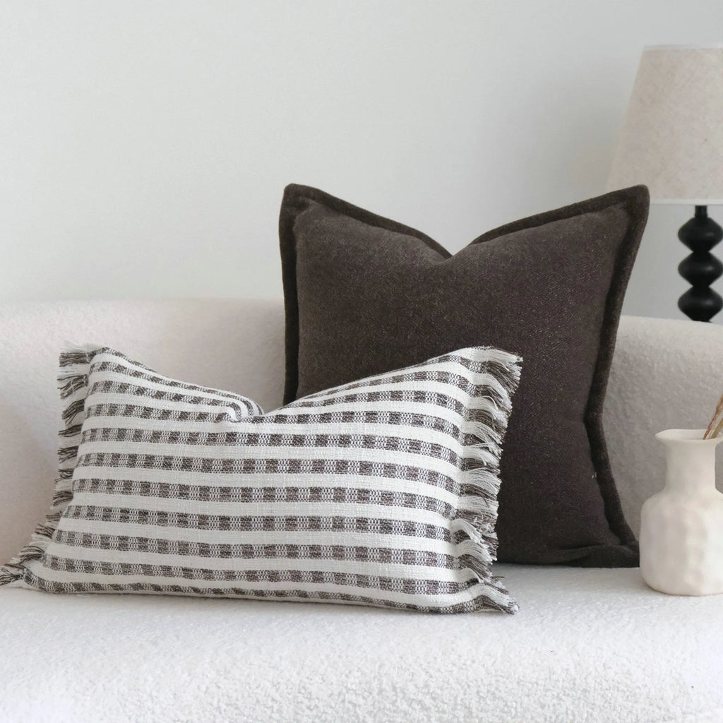 Coffee brown striped Chinese classical style decorative cushion on a sofa.