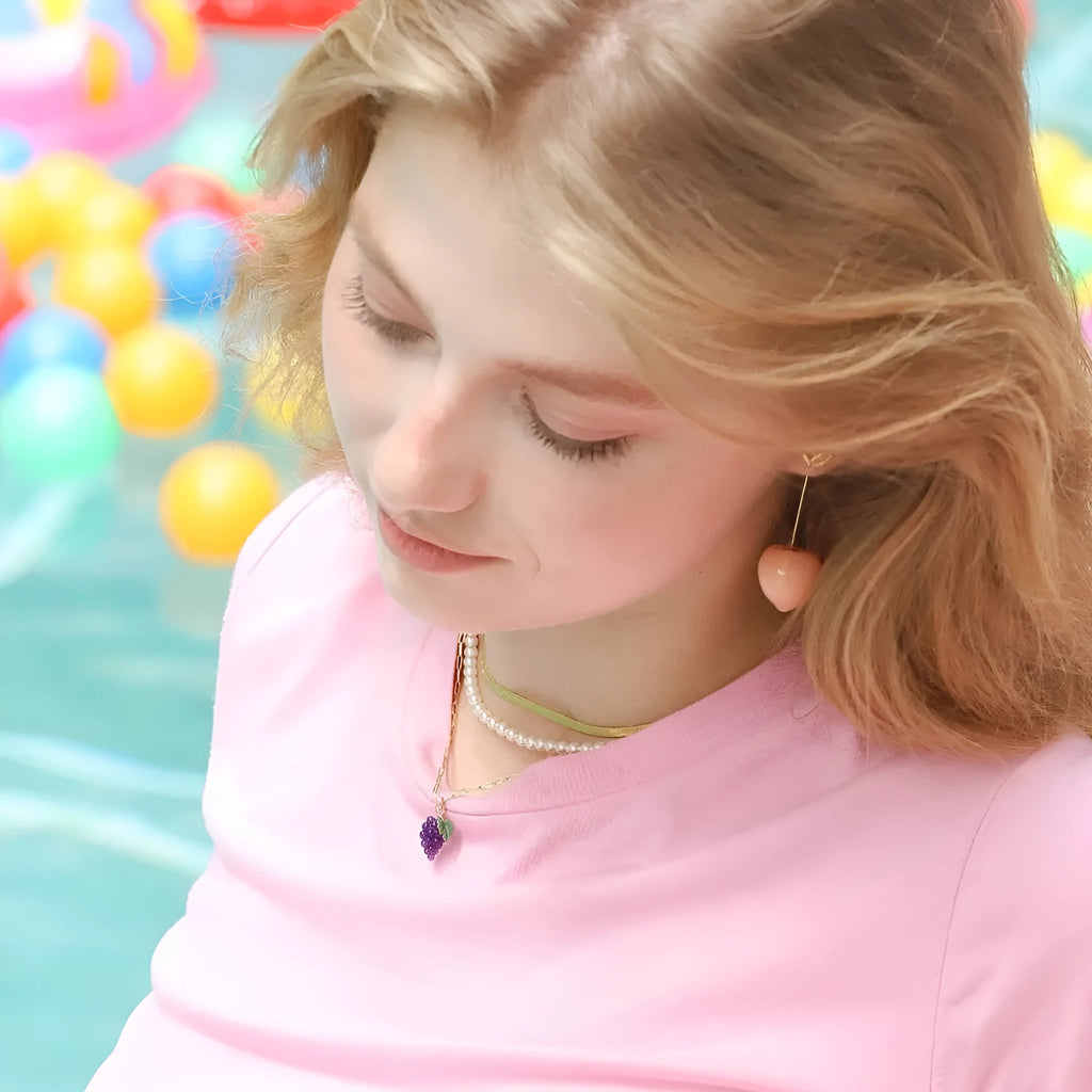 Gold plated fruit and vegetable design earrings showing seven colour variations on copper with electroplated finish