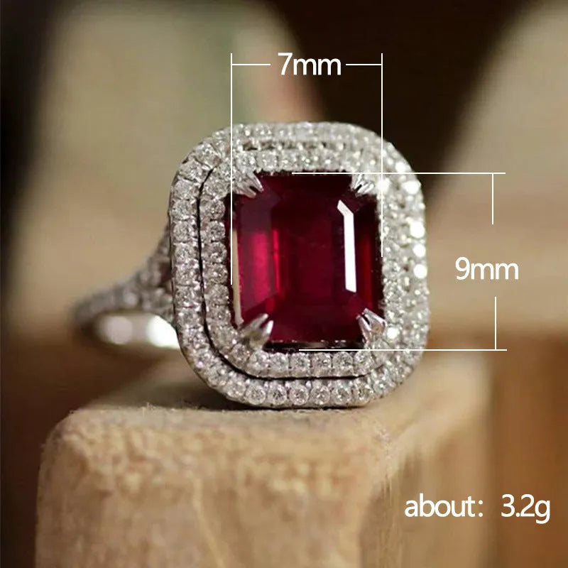 Copper square women's ring with a central red rhinestone on a hand model.