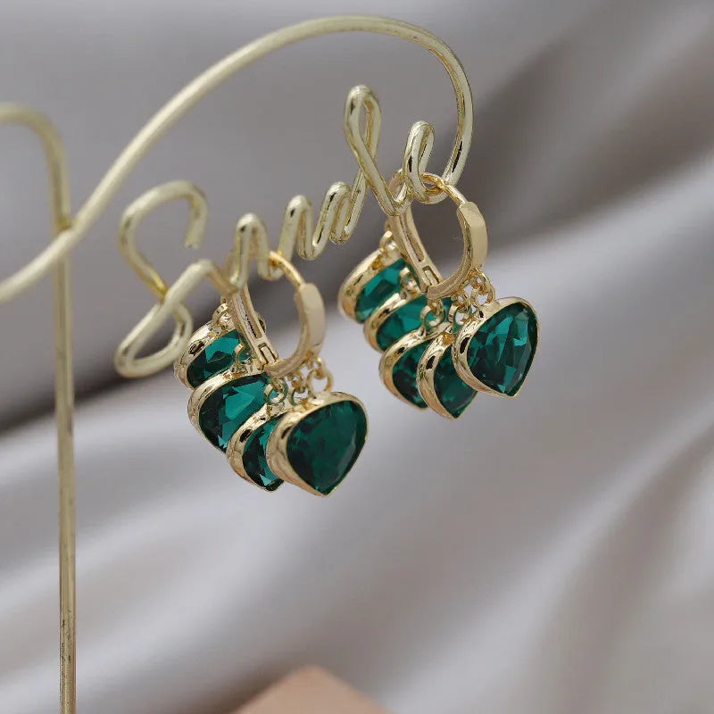 Green heart-shaped glass pendant ear clip earrings with alloy gemstone inlays on copper frame