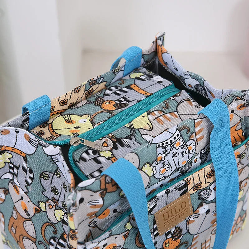 Women's large square canvas handbag with aluminium handles in a choice of printed floral and cat designs.