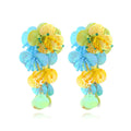 Handmade exaggerated string bead flower earrings in colourful, rose, or purple on a white background.