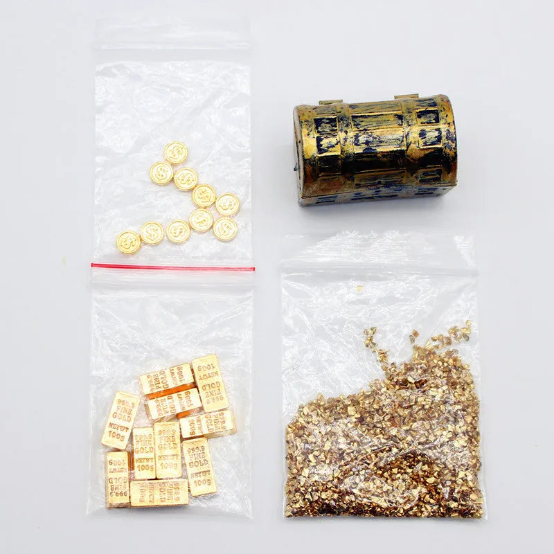 Miniature alloy gold coin and gold bar doll house accessory ornaments on display.