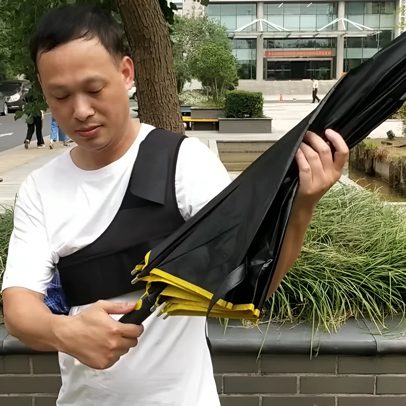 Black portable umbrella holder with shoulder strap for hands-free carrying
