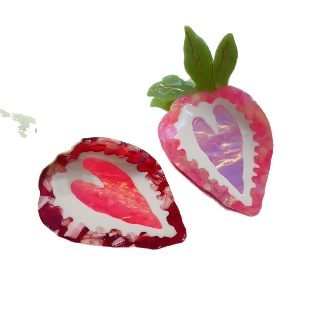 Handmade red and pink strawberry hairpin for girls on a white background.