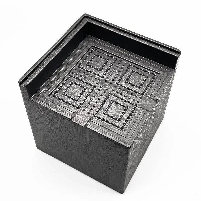 Four black plastic bed foot mats for increasing sofa or furniture height.
