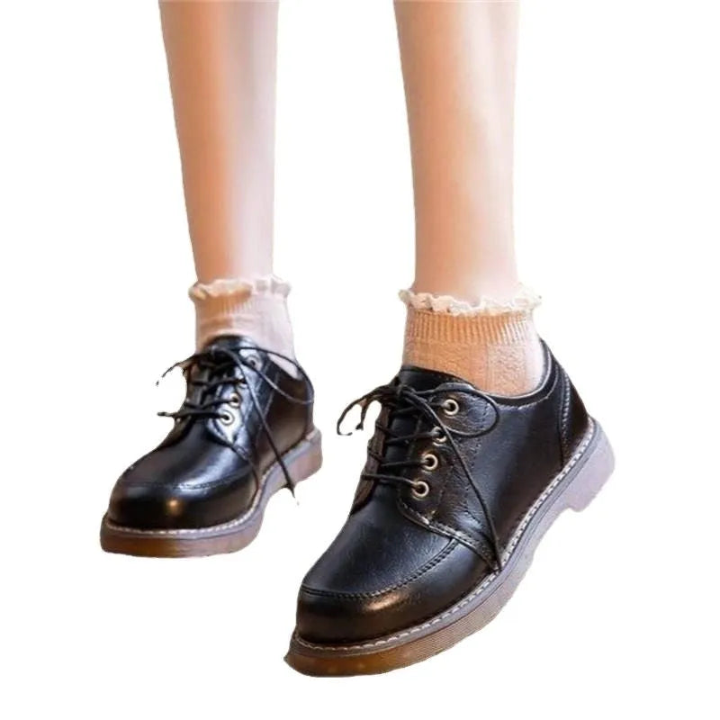 Women's preppy style black and brown retro Mary Jane lace-up pumps with low square heel.
