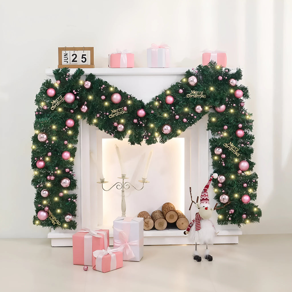 Pink artificial rattan Christmas garland with small fruit and LED lights draped over a banister