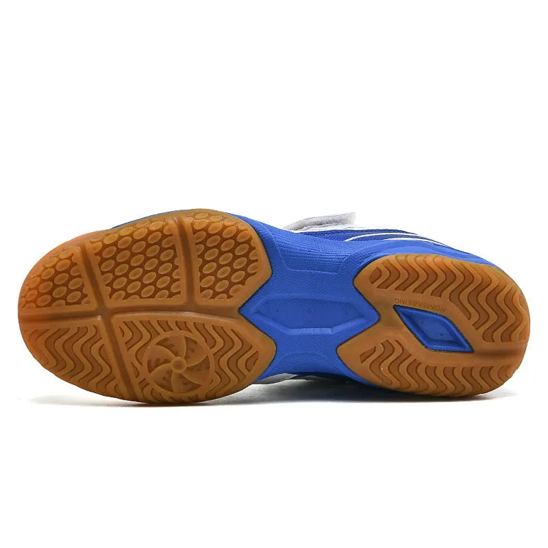 White and blue low-top badminton shoes with a ribbed sole and wedge heel.